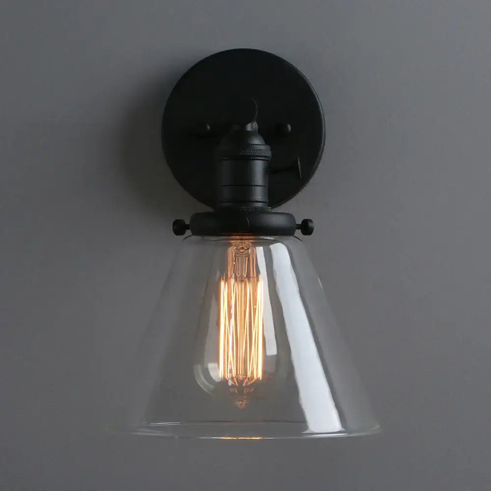 Industrial black wrought iron wall sconce with clear glass shade and exposed filament bulb for kitchen decorbites cone canopy wall