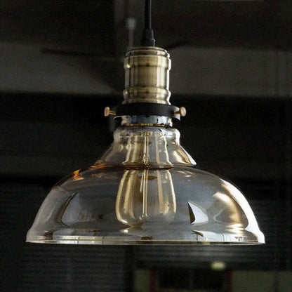 Industrial brass glass pendant light with clear glass dome and brass-finished metal fixture for dining room lighting
