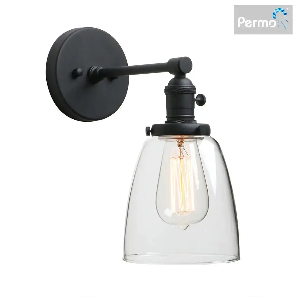 Black metal wall sconce light with clear glass shade and exposed filament bulb for industrial bedroom fixture