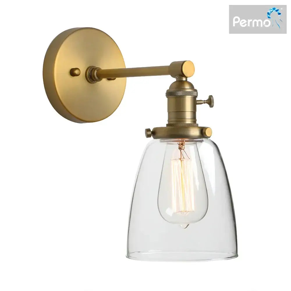 Industrial brass glass wall sconce light with brass finish clear glass shade and exposed filament bulb for bedroom use