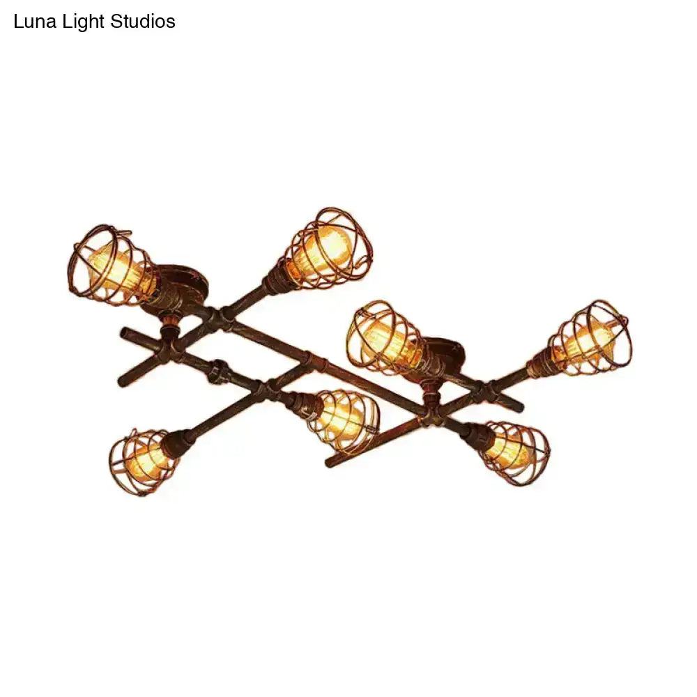 Industrial brass intersecting piping ceiling light with six warm bulbs in wrought iron cages on dark bronze frame
