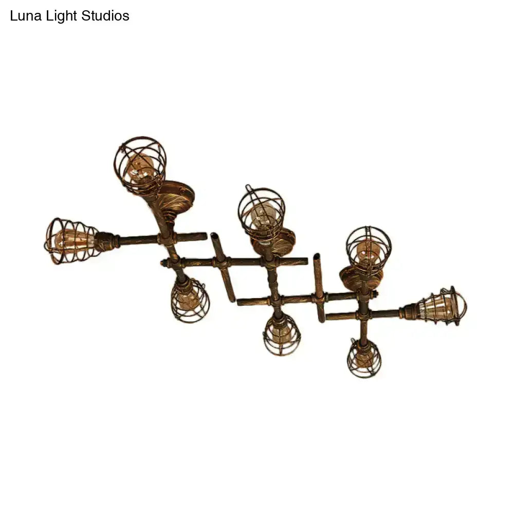 Industrial brass intersecting piping ceiling light with six exposed filament bulbs in wire cage for dining room