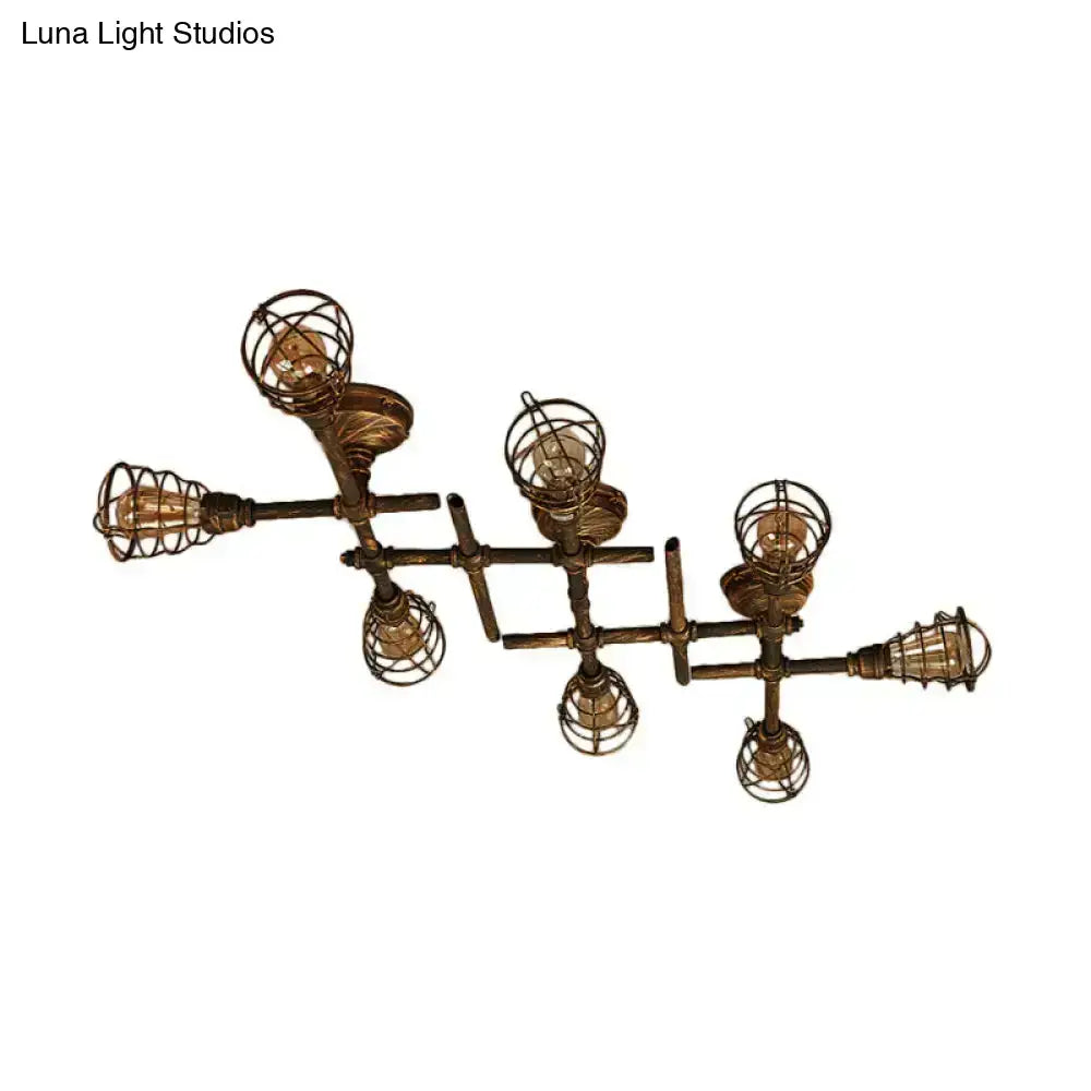 Industrial brass intersecting piping ceiling light with five filament bulbs encased in wire cages for dining room use