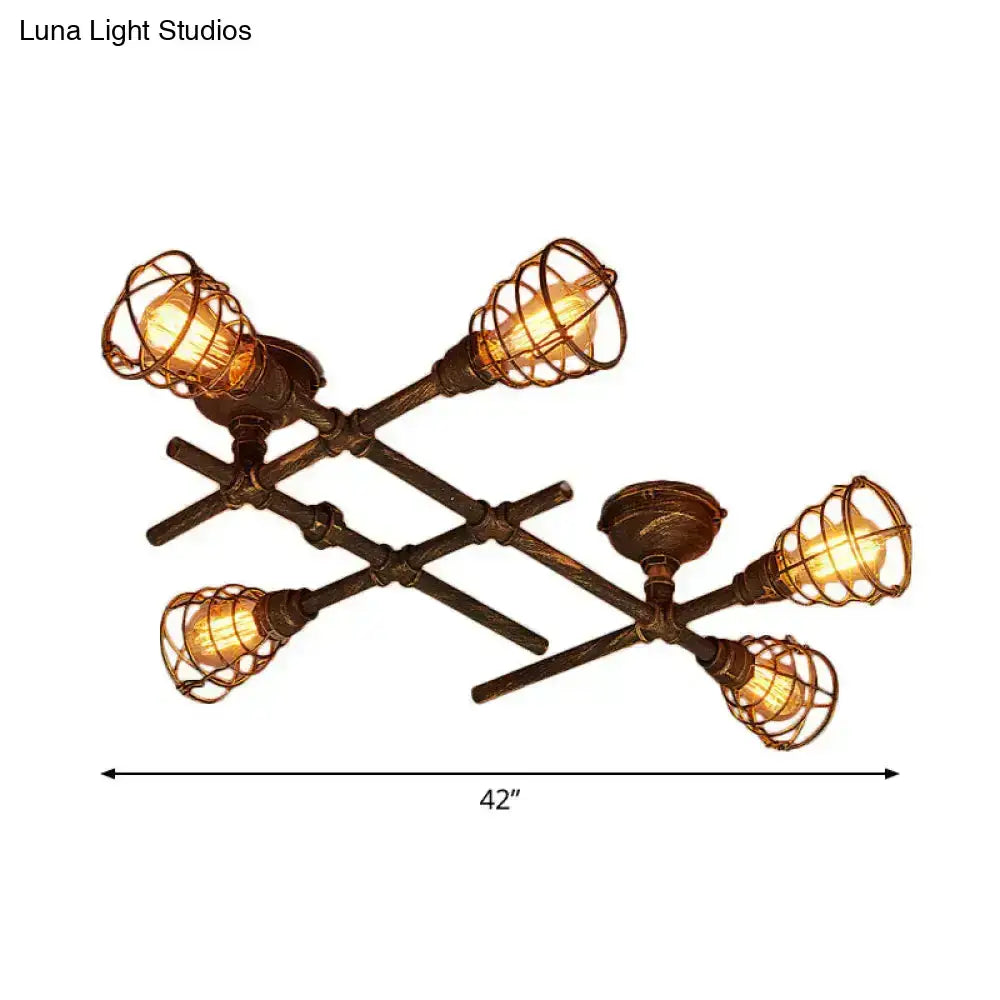 Industrial brass intersecting piping ceiling light with four filament bulbs in dark bronze cage for dining room use