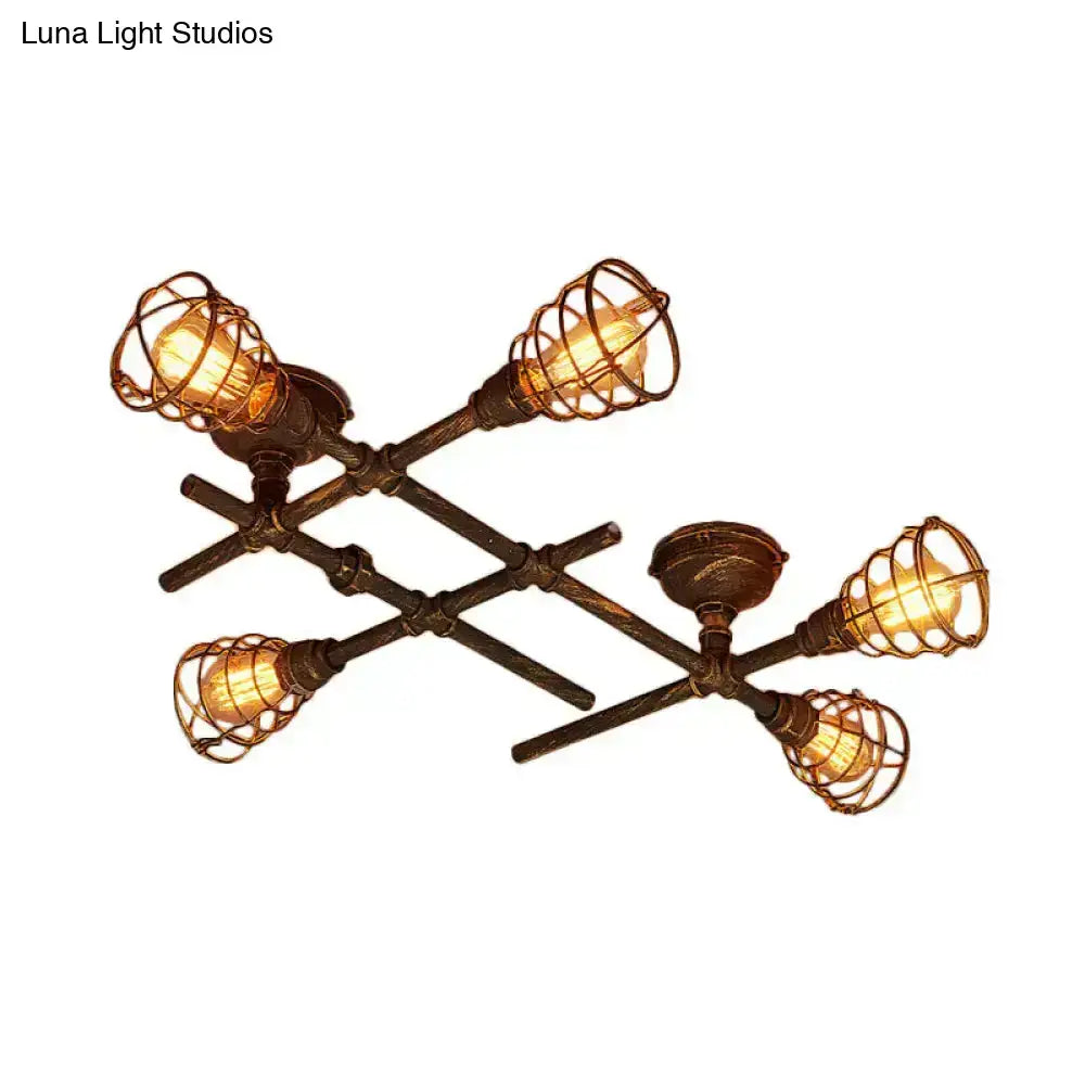 Industrial brass intersecting piping ceiling light with four filament bulbs in bronze wire cage for dining room use