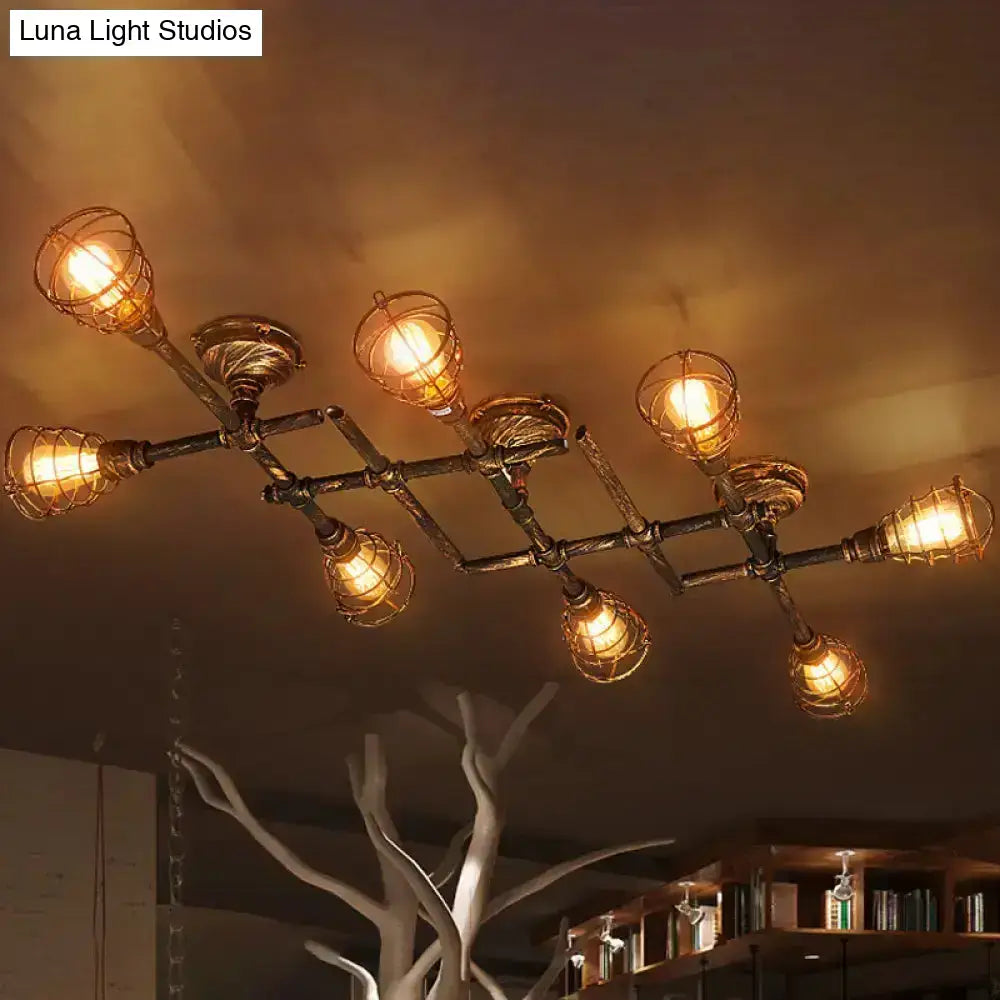 Industrial brass intersecting piping ceiling light with six warm bulbs in wire cages for dining room use