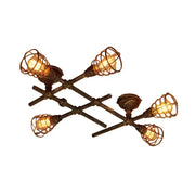 Industrial brass intersecting piping ceiling light with four exposed filament bulbs in dark bronze wire cages for dining room