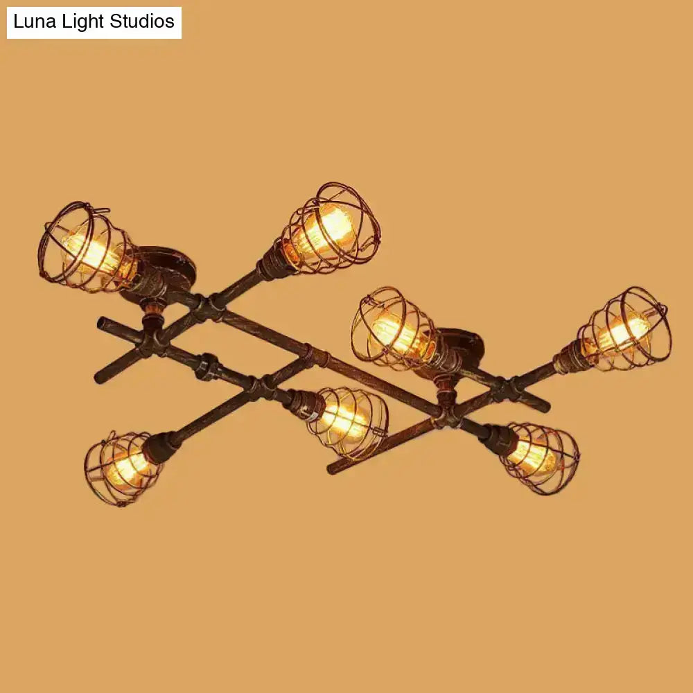 Industrial brass intersecting piping ceiling light with six filament bulbs in wire cages on dark metal frame for dining room