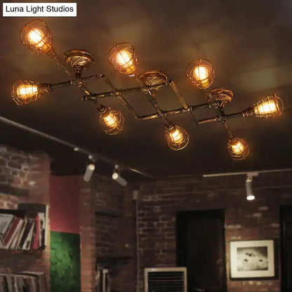 Industrial brass intersecting piping ceiling light with warm bulbs in wire cages on dark metal frame for dining room