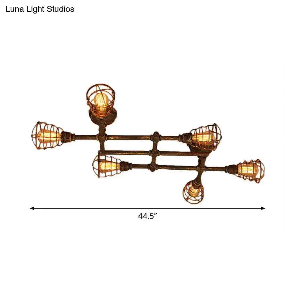 Industrial brass intersecting piping ceiling light with five exposed filament bulbs and wire cages for dining room use