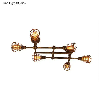 Industrial brass intersecting piping ceiling light with five exposed filament bulbs in dark bronze wire cages for dining room