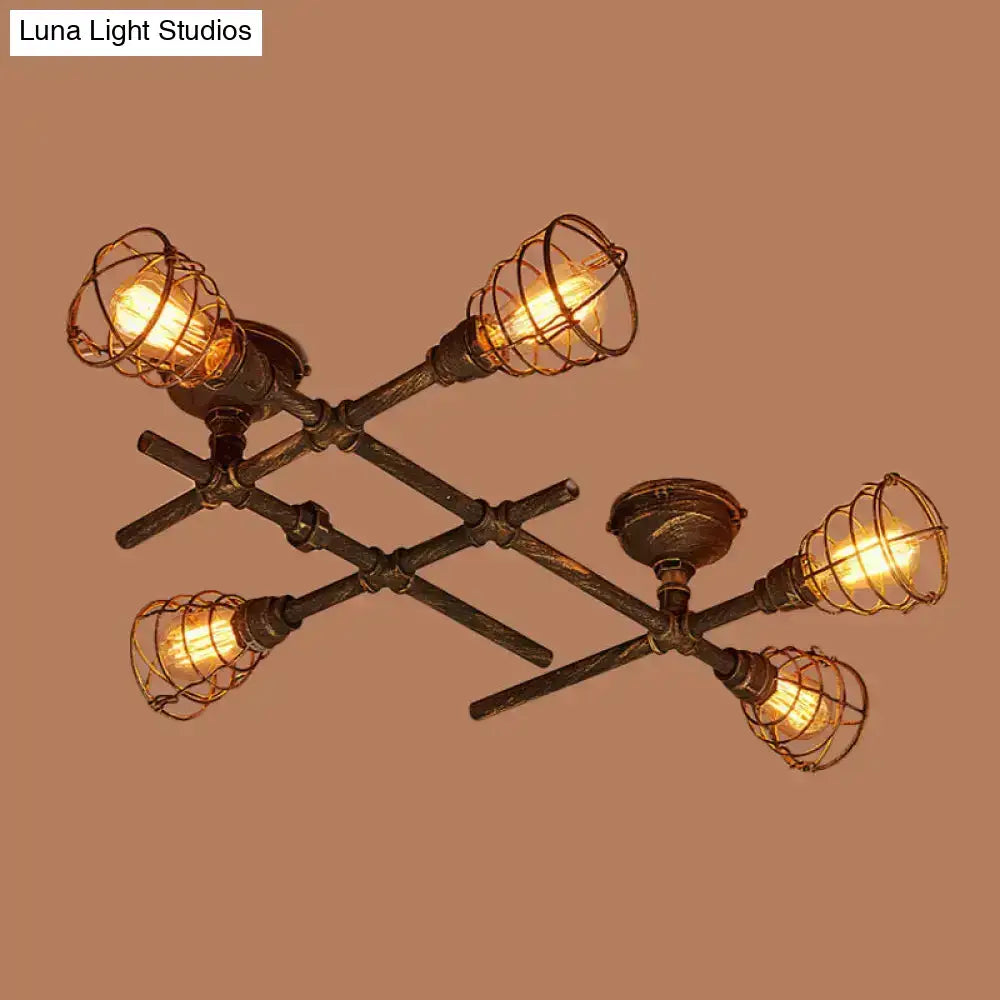Industrial intersecting piping ceiling light with four filament bulbs in dark bronze wire cages for dining room use