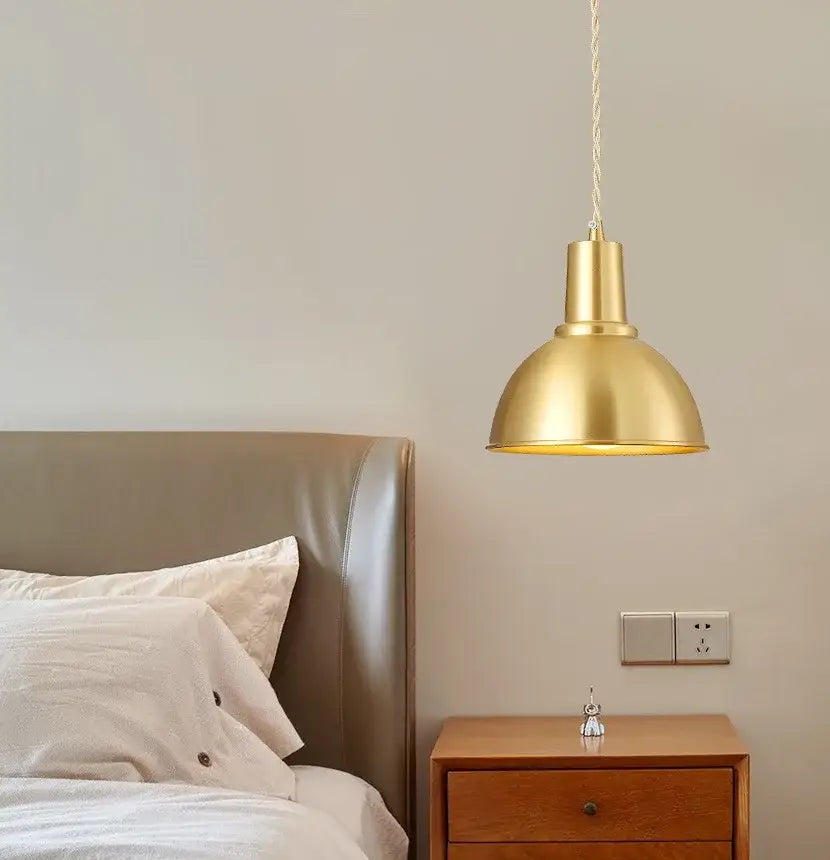 A brass pendant light with a sleek dome-shaped shade and twisted cord suspension for industrial kitchen decorbites iron art