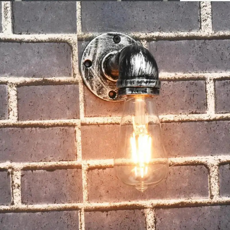 Industrial brass pipe wall sconce with blackened metal industrial iron pipe and exposed filament bulb for bedroom decorbites industrial iron style
