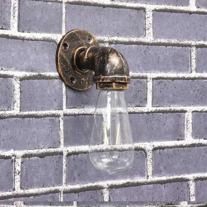 Industrial brass pipe wall sconce with clear glass bulb featuring decorbites industrial iron pipe design for bedroom lighting