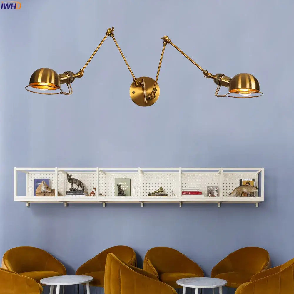 Brass-colored industrial swing arm wall sconce with two dome-shaped lights for bedroom reading decorbites industrial swing