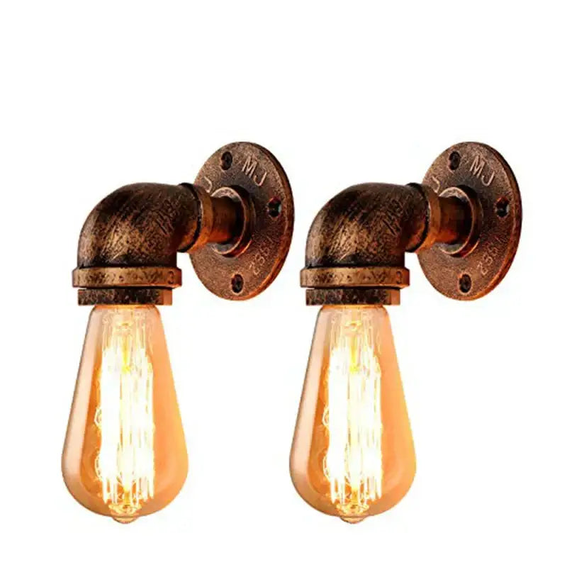 Industrial bronze and black wall lamp with warm filament bulbs and brass-finished industrial water pipe fixtures for bedroom use