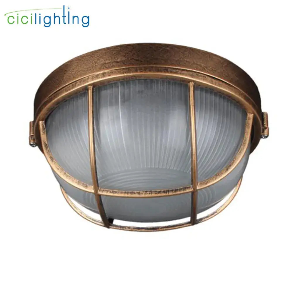 Antique brass-finished industrial-style outdoor ceiling lamp with frosted glass dome and bronze metal cage for yard lighting