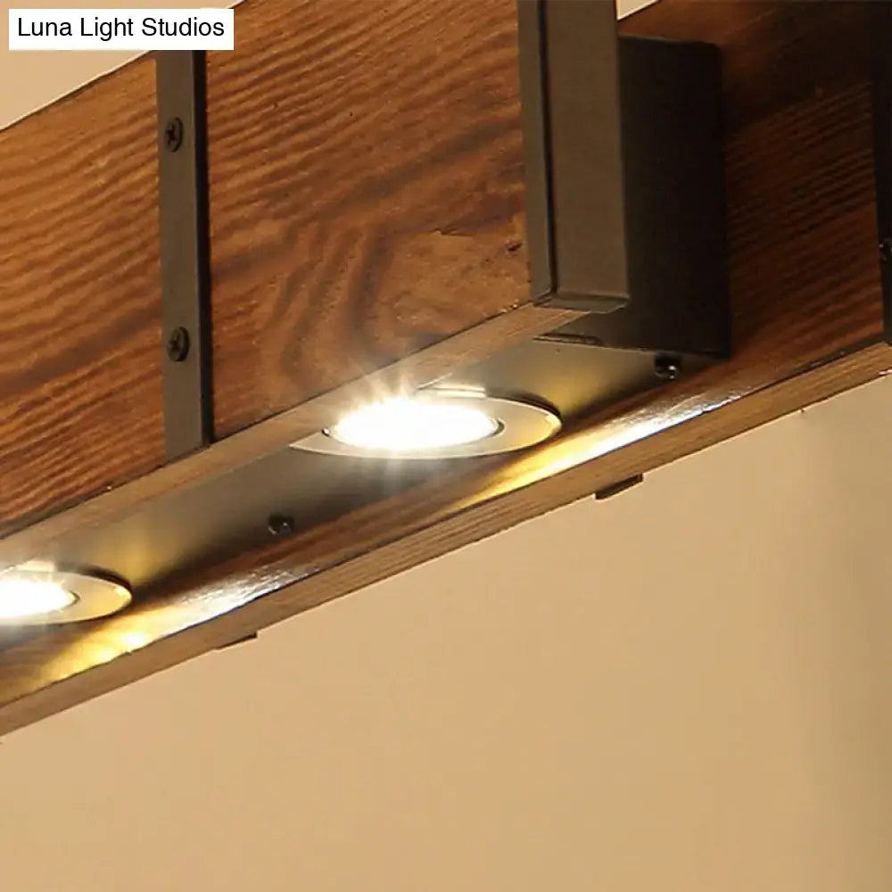Warm-toned recessed island ceiling light with sleek metallic fixtures mounted beneath an industrial brown rectangular wooden island beam