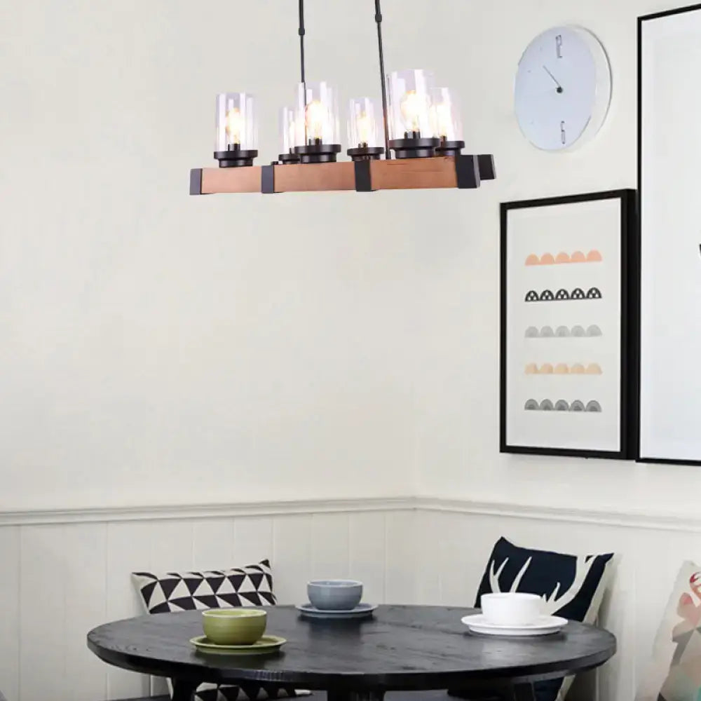 A modern farmhouse-style decorbites™ industrial brown island lighting with clear glass cylinder shades for dining rooms