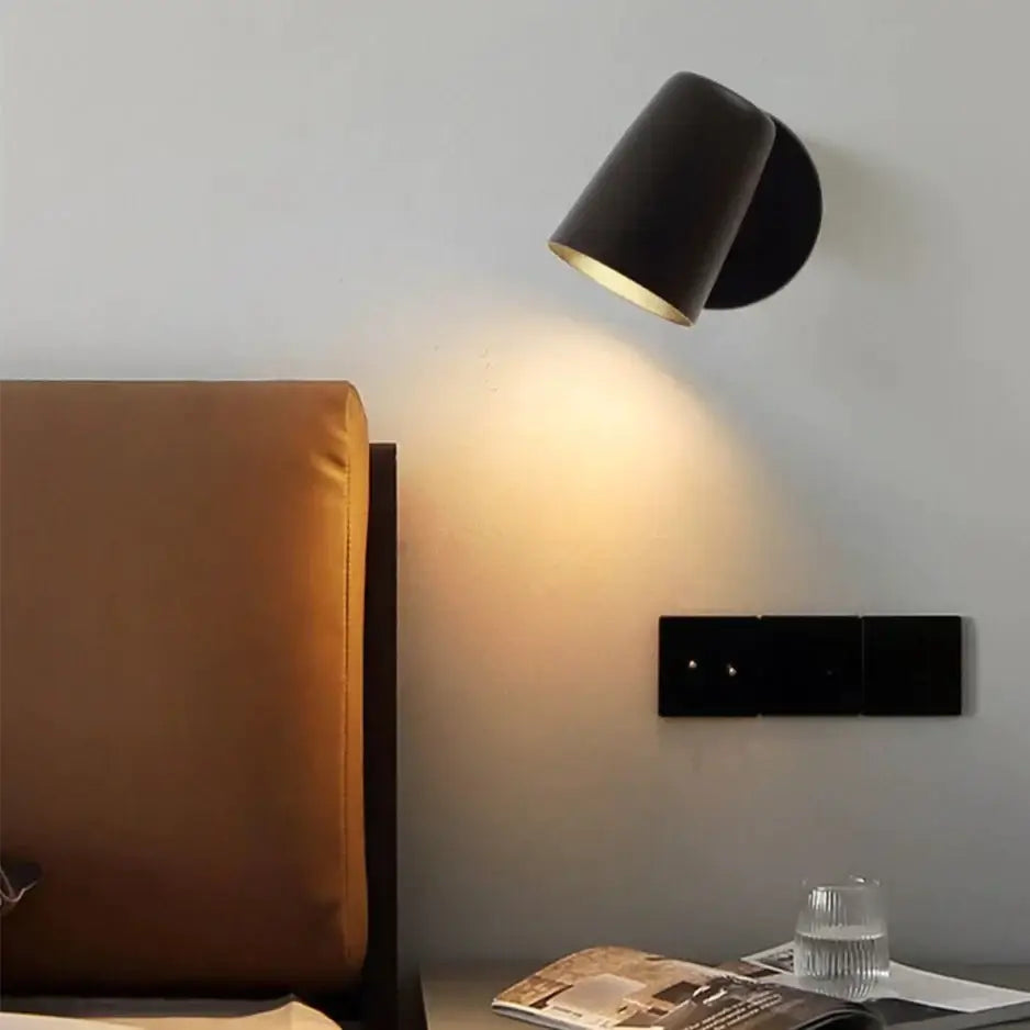 Industrial led wall sconce with black cylindrical matte finish and gold-toned interior for bedroom spotlight lighting