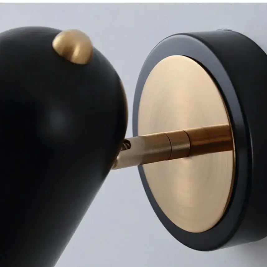 Industrial led wall sconce with black and brass minimalist design and rounded shade for bedroom spotlight use