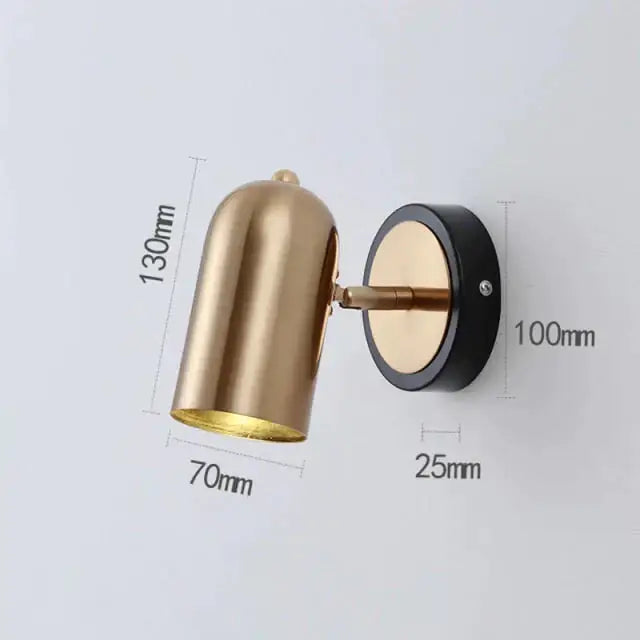 Industrial led wall sconce with brass finish, cylindrical shade, and black base for bedroom spotlight lighting