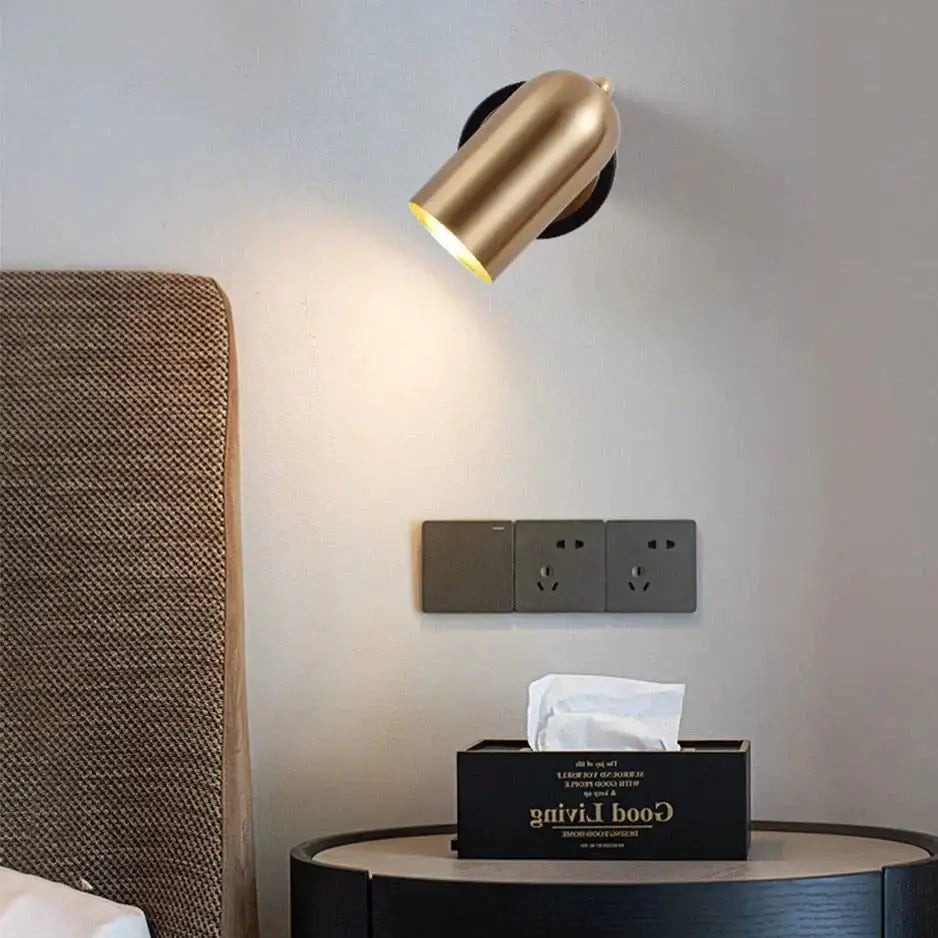 Gold-finished industrial led wall spotlight with cylindrical shape, adjustable head, and sleek metallic finish for bedroom use