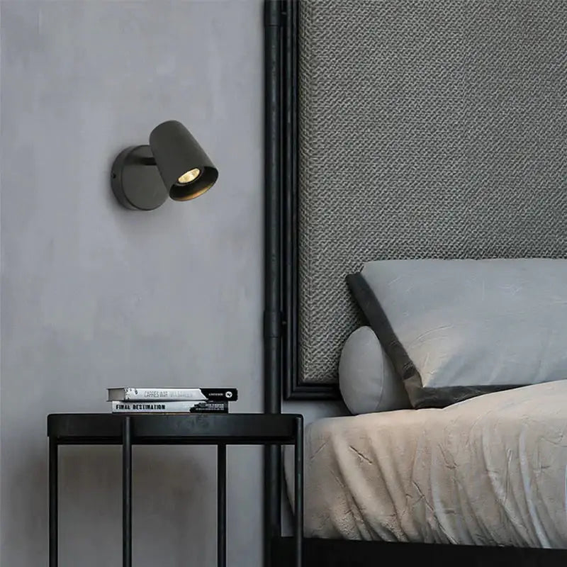 A sleek matte black industrial led wall spotlight with modern design for bedroom mounted on wall