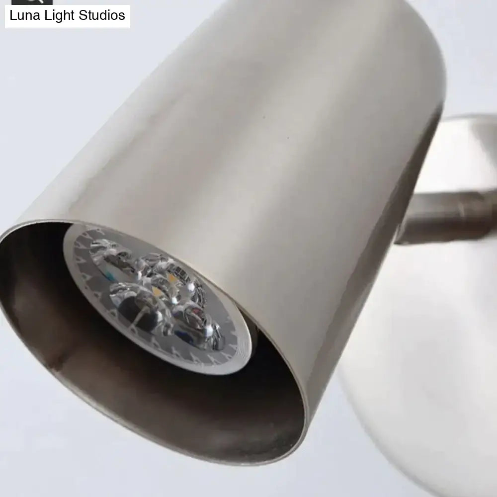 Industrial brushed nickel led wall sconce with stainless steel cylindrical design and visible led bulb assembly