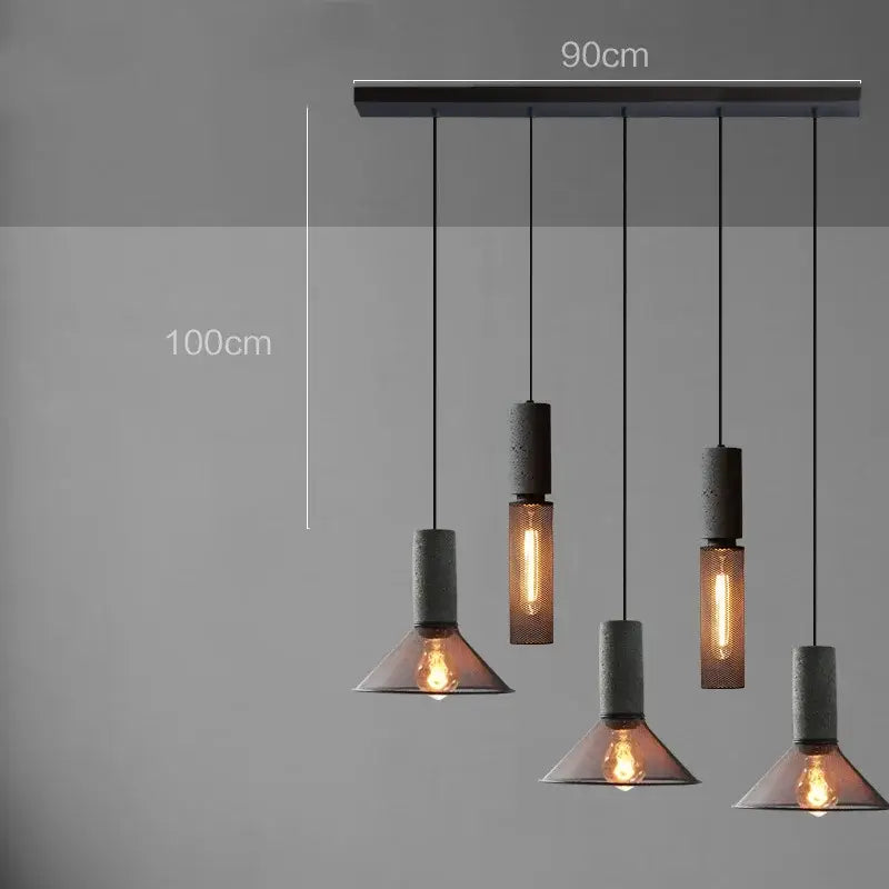 Industrial cement metal pendant light with matte black concrete bar and textured gray and amber glass shades for dining room