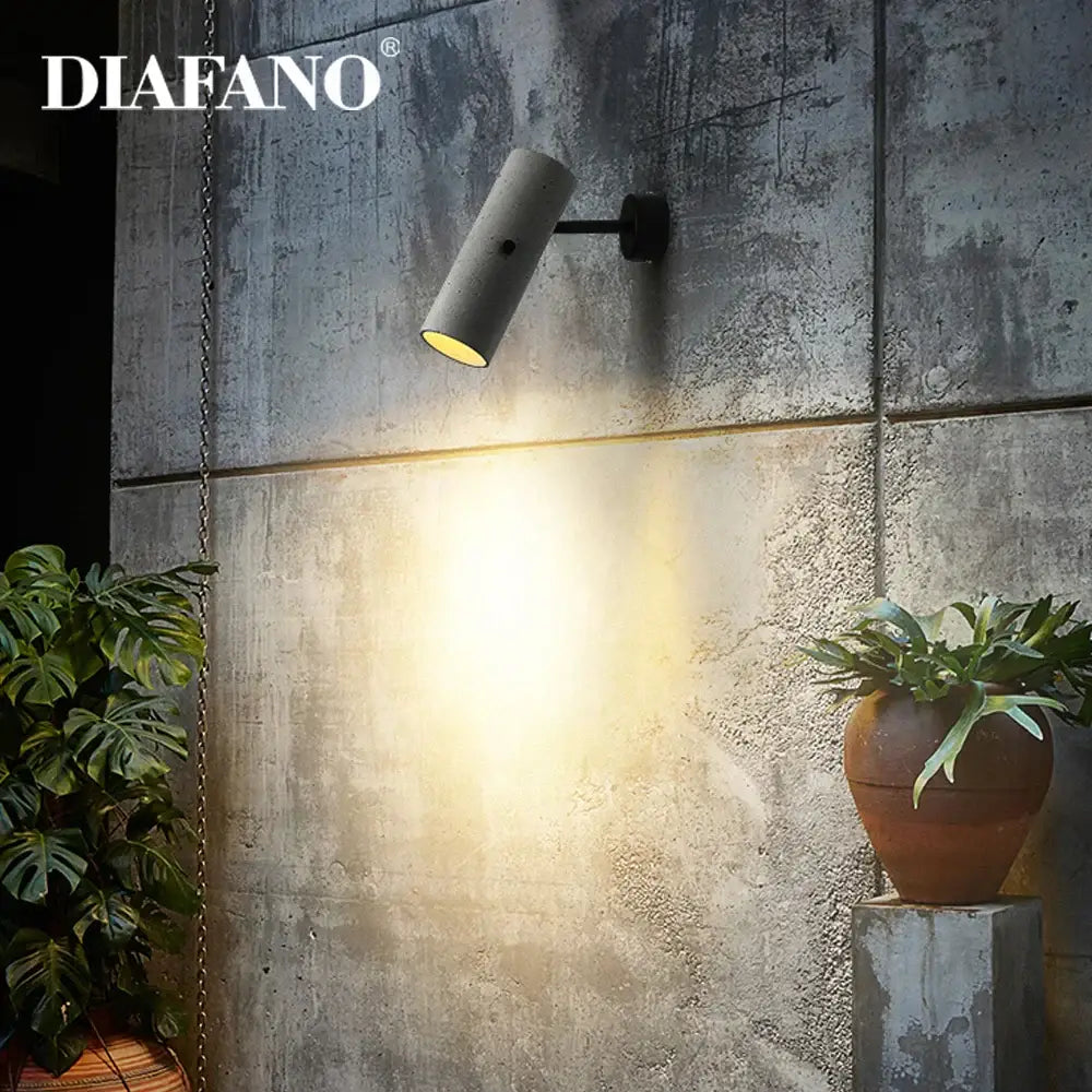 Diafano industrial cement wall lamp with matte gray cylindrical design and warm yellow light for living room decorbites industrial cement