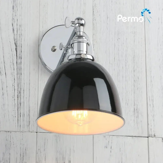 Industrial chrome and black wall sconce lights with a glossy dome shade and exposed filament bulb for bedroom use