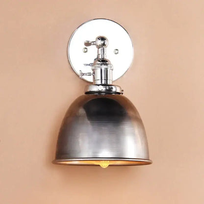 Industrial chrome and black wall sconce lights with a brushed metallic finish and a domed shade for bedroom use