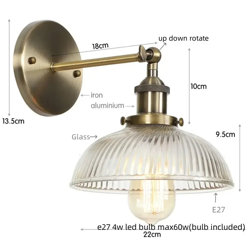 Antique brass finished wall sconce with ribbed clear glass shade and exposed Edison bulb for decorbites clear glass lighting