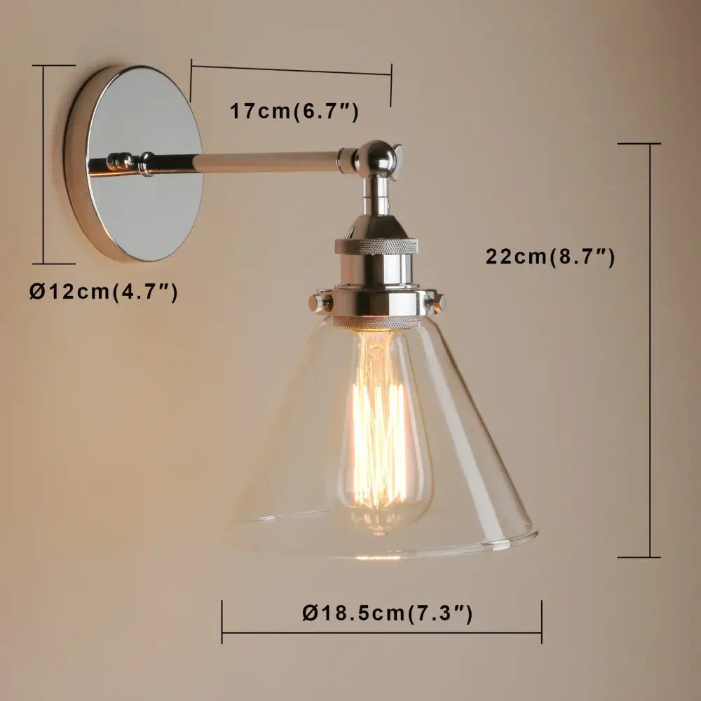 A sleek chrome wall sconce with a clear glass shade and exposed edison bulb for bedroom light fixture use