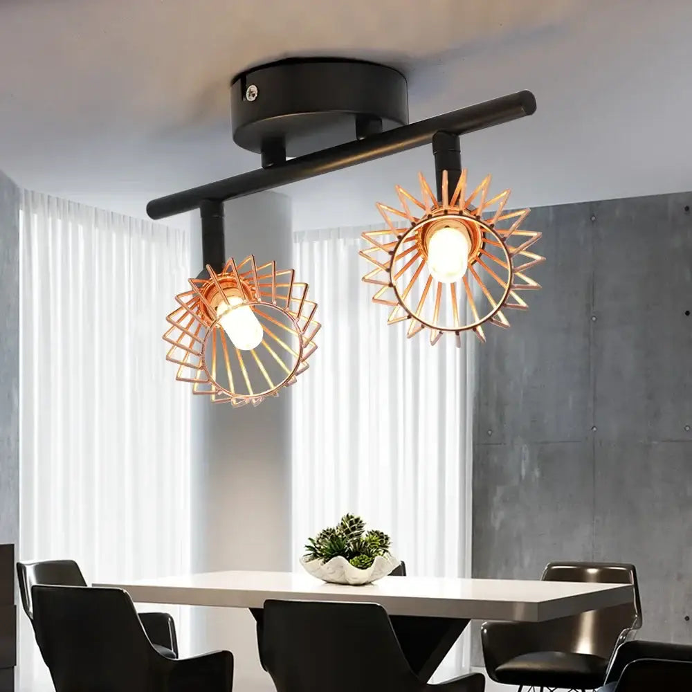 Industrial copper diamond cage chandelier with two sunburst-shaped copper metal shades and black central bar ceiling mount