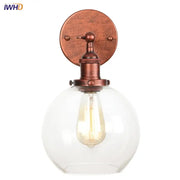 Copper-finished industrial wall sconce with clear decorbites glass globe housing a glass globe led bulb for bedroom light