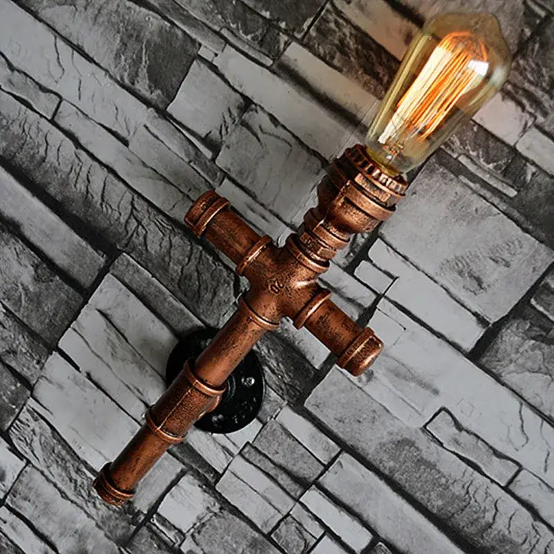 Copper-colored industrial iron pipe wall sconce with vintage filament bulb for decorbites industrial iron living room decor