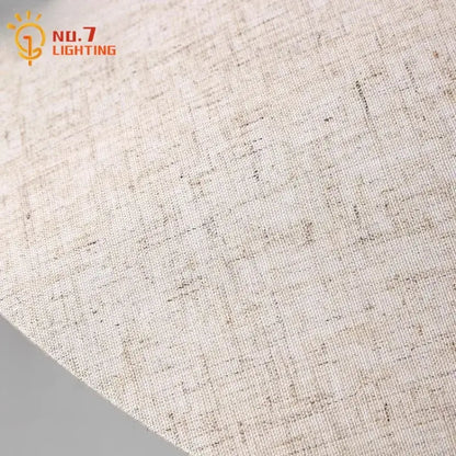 Beige linen fabric with subtle textured weave complements industrial cream ceramic table lamp for decorbites concrete led table use