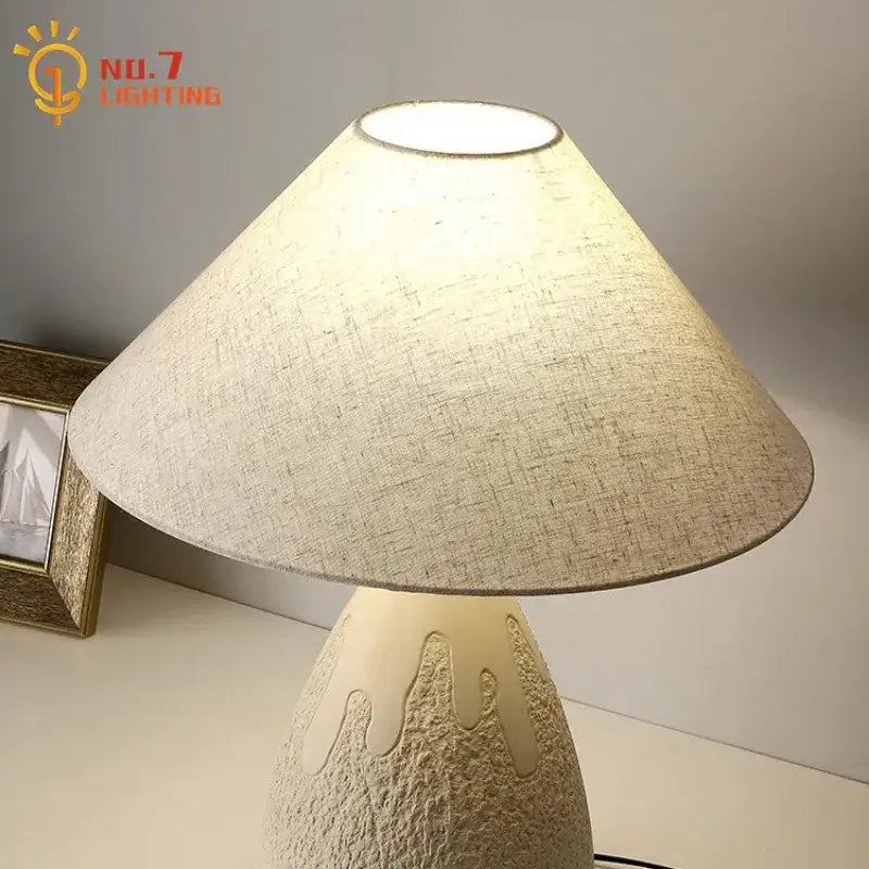 Industrial cream ceramic table lamp with textured cream lampshade on decorbites concrete led table base