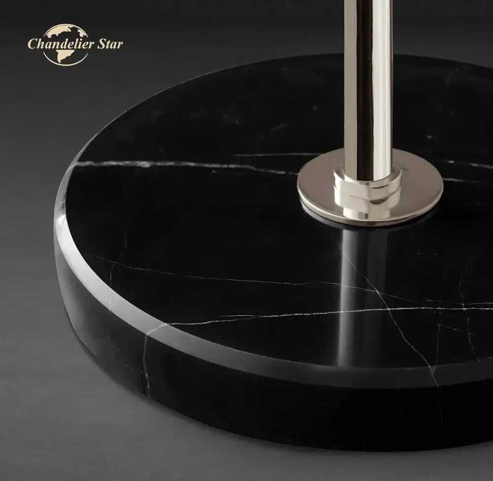 Black marble base floor lamp with polished silver-toned metal stem and circular plate by Decorbites industrial crystal led