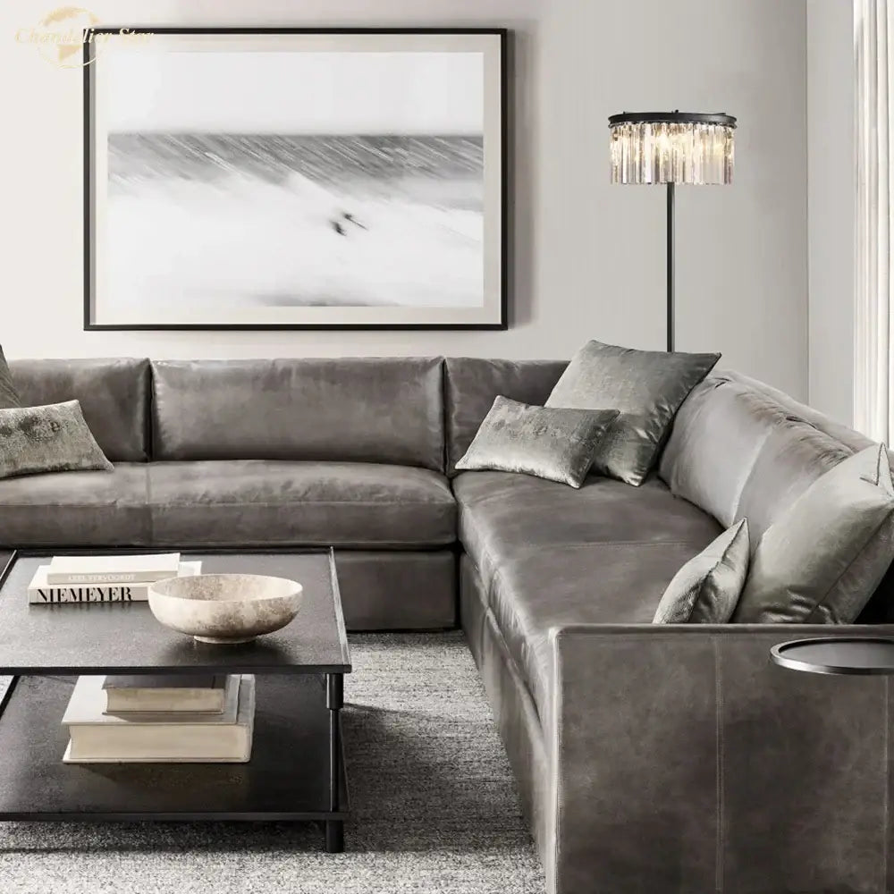 Gray velvet sectional sofa with matching throw pillows next to decorbites industrial crystal led black chrome floor lamp