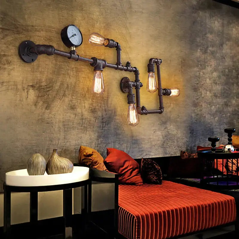 Industrial dark brass pipe wall lights featuring rustic metal pipes and exposed filament bulbs for living room use