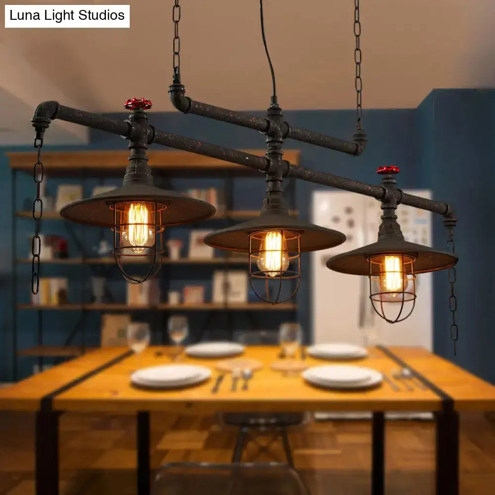 Industrial-style black pipe cone island pendant light with three exposed bulbs and red valve accents by decorbites