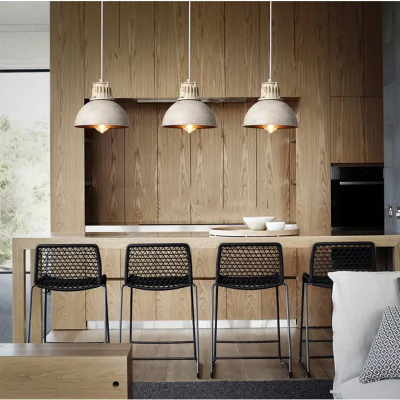 Three industrial pendant lamps with distressed white metal shades hang above a wooden kitchen island decorbites loft chandelier