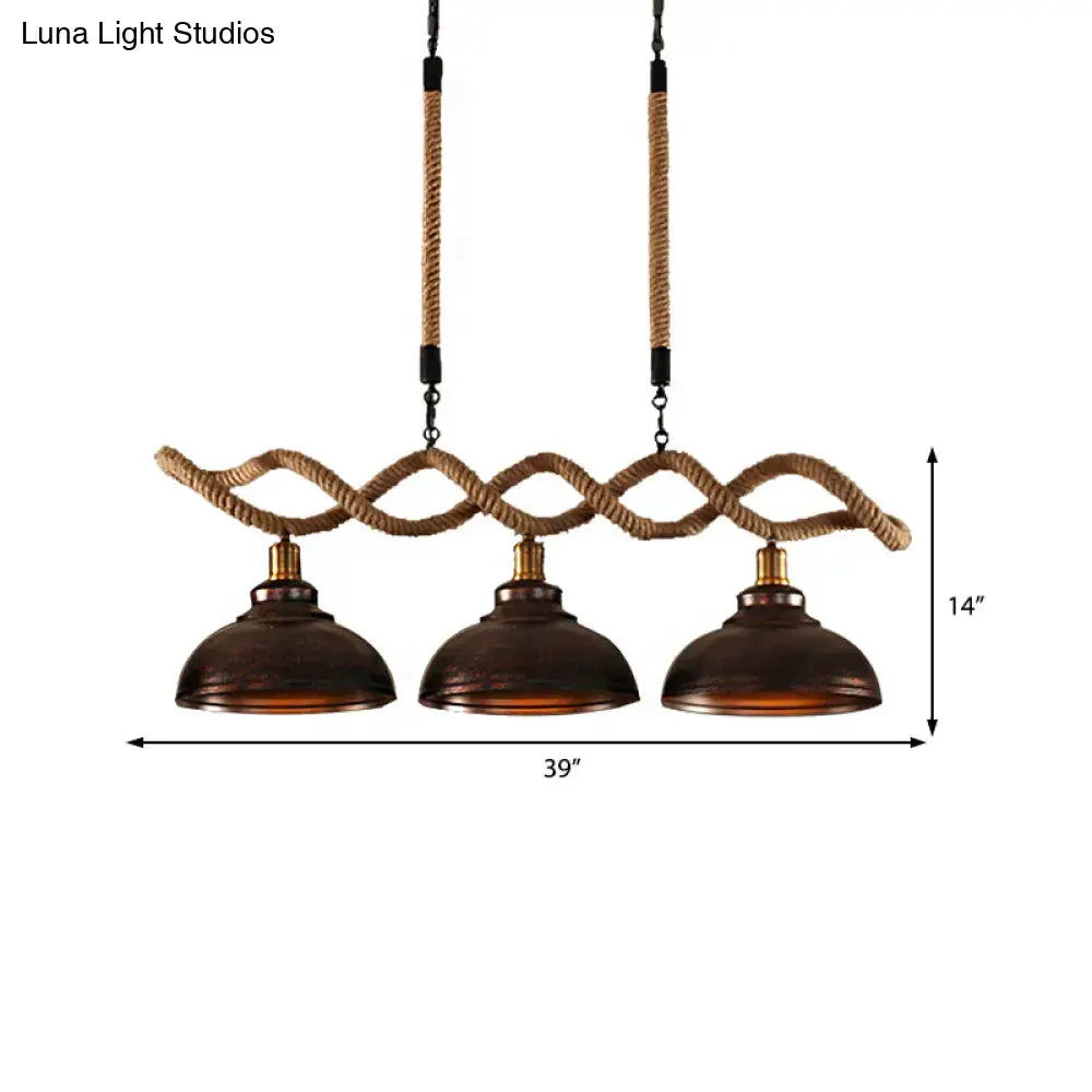 Rustic bronze pendant light with three dome kitchen island shades suspended by twisted rope and black hardware