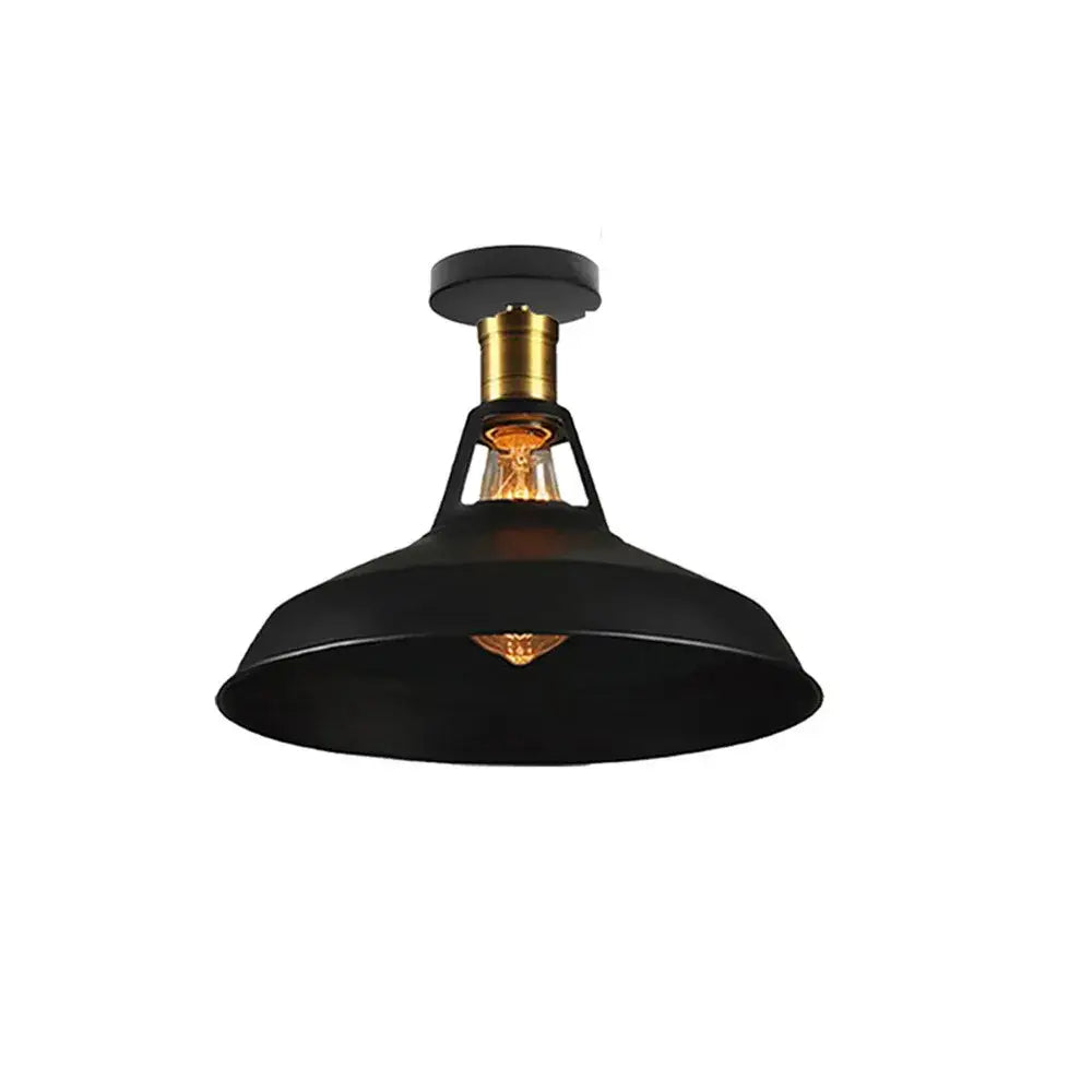Black industrial-style metal ceiling light shade with brass-finished base and exposed filament bulb for kitchen bar lighting