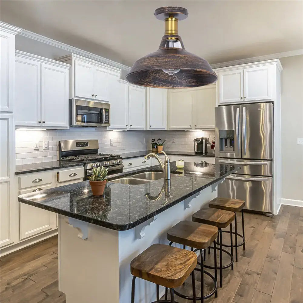Bronze industrial pendant ceiling light shade with brass accents hanging above kitchen island for bar lighting