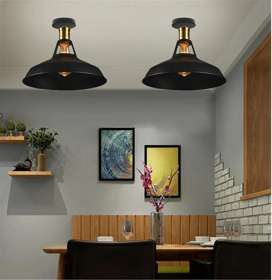 Black industrial dome metal ceiling light shade with brass accents and exposed filament bulbs for kitchen bar lighting